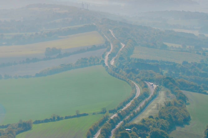 An aerial view looking east along the Hogs Back towards Guildford