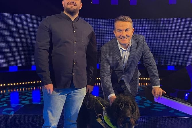 Lloyd Davies on the set of The Chase with guide dog Harvey in harness, plus quizmaster Bradley Walsh