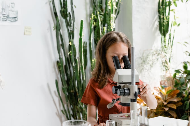 child and microscope