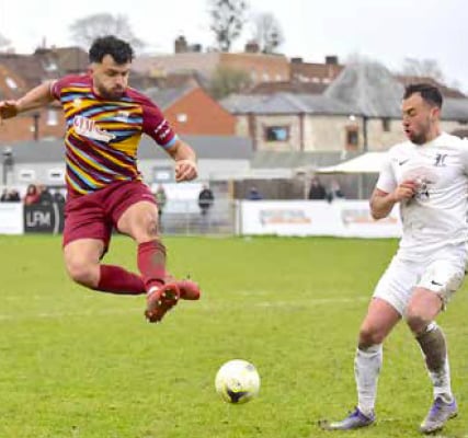 Farnham’s Arsen Ujkaj flies into a tackle against Horley
