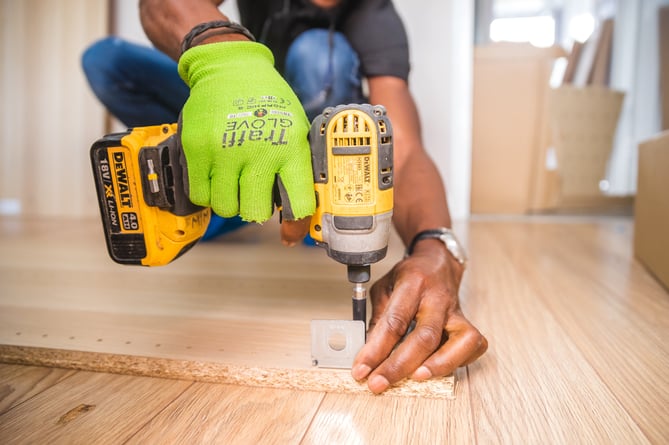 A person using a power drill.