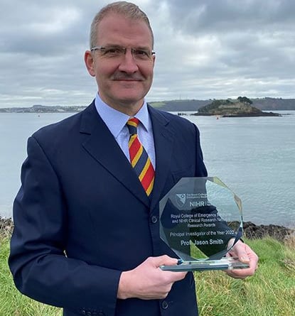 Surgeon Capt Jason Smith with his award
