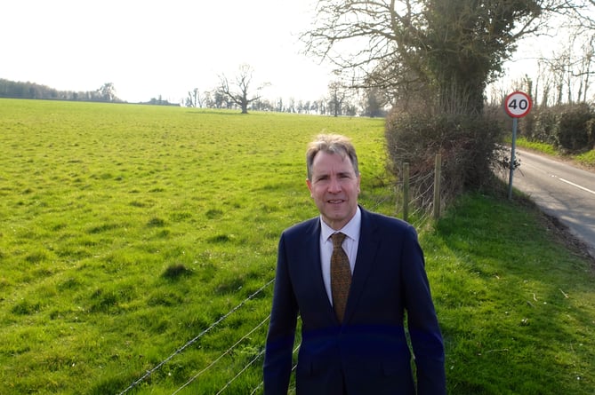 Dan Norris standing next to a field in the West of England Green Belt area. 