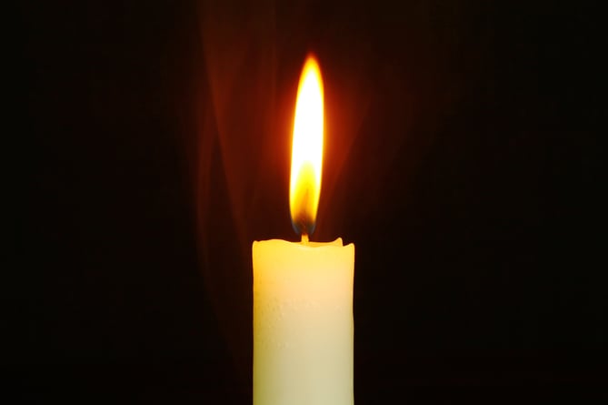 A candle lit at a church.