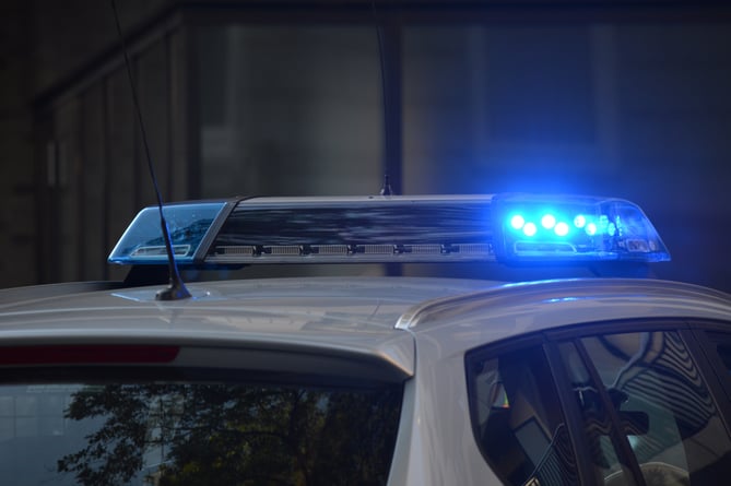 Police car with lights and sirens.
