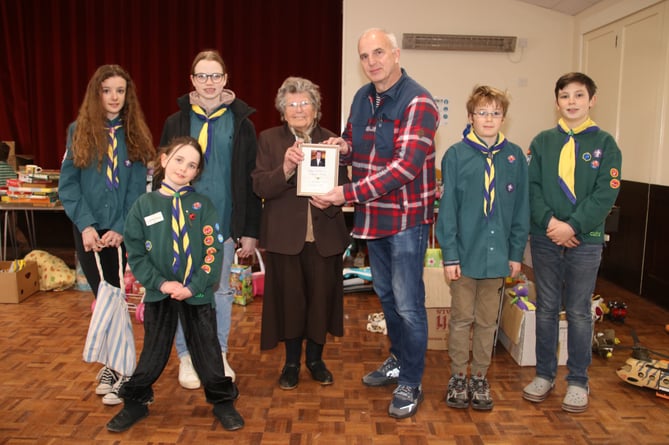 Margaret Phillips presenting Steve Haley, Sandford Scouts Chairman, with her First Sandford Scout Secretary Badge, from 1955. AQ 5765