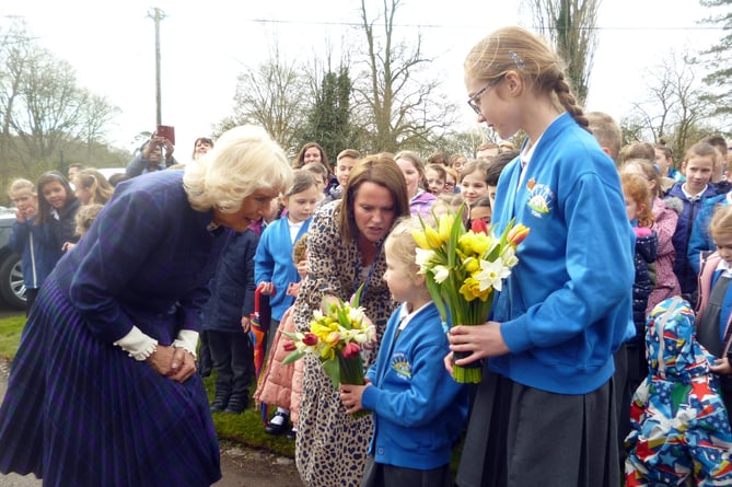 The Duchess of Cornwall receives flowers from Chawton CE Primary School pupils Cecily Hook, four, and Holly Bayliss, 11, as she visits Jane Austen’s House in Chawton on April 6th 2022.