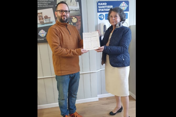 Cllr Rosemarie Harris, receives the ‘Say Yes to Llanigon Green Space Petition’ from Gwernyfed Community Councillor and campaigner, William Lloyd