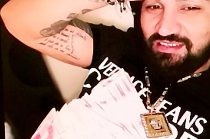 Bogdan Florea - Police found pictures on Florea's phone of him posing with large amounts of cash. A burglar who targeted chemists for perfumes has been jailed for four and a half years. See SWNS story SWNNperfume. Bogdan Florea, 33, from Farnborough, Hampshire, committed a string of offences between July and September 2021. He was caught after his car was spotted near a break-in in Reading, Berkshire. On Monday at Guildford Crown Court, he was sentenced to 54 months jail after pleading guilty to burglary and possession of false ID. Two cars belonging to him were also ordered to be seized and destroyed.