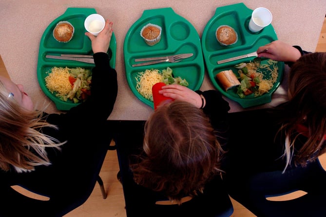 PARENTAL PERMISSION OBTAINED. Generic picture of pupils enjoying school dinners at a Primary School in Cambridgeshire.