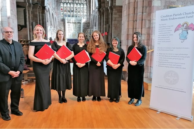 Stephen Tanner with Isca Voices - former Girl Choristers from Exeter Cathedral. Standing next to him is local girl, now an elegant young lady, Ottilie Hankin who used to sing with the Church Choir.