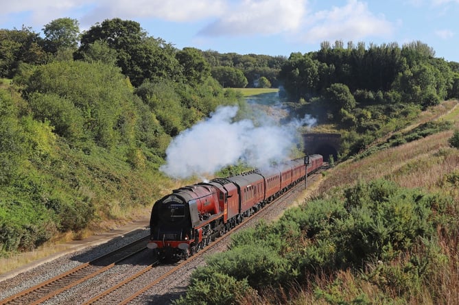 Ex-LMS Coronation Class pacific locomotive Duchess of Sutherland emerging from Whiteball Tunnel, on the border of Devon and Somerset, while on a previous visit to the South West in 2019.