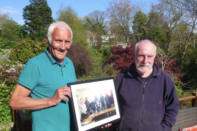 Mike Walker (left) presents a framed photograph to Adrian Kendon (right) to mark his retirement as Chair of Traws Link Cymru