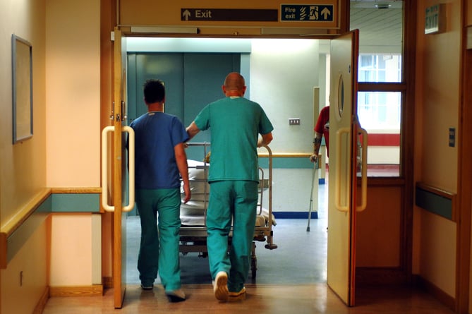 Orderlies push a bed at the Royal Orthopaedic Hospital, Oswestry.