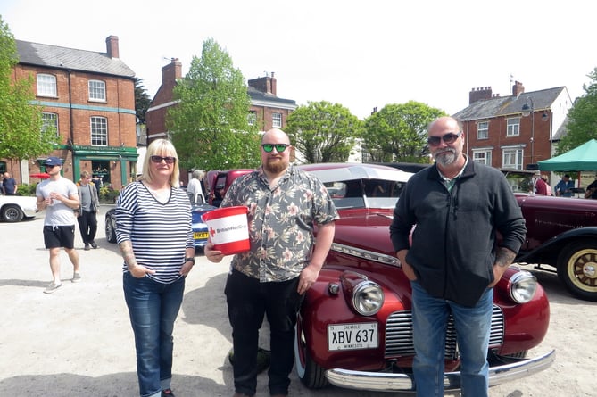 Dan Webb with his collecting bucket for the  British Red Cross beside probably his favourite vehicle that morning, a 1940 Chevrolet Special de Luxe with its owners Simon and Caroline Cornford of Sampford Courtenay.  SR 1774
