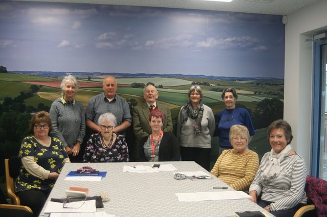 Members of Redlands Primary Care Surgery League of Friends, standing in front of the huge photograph of farmland near Sandford that is on the wall in one of the meeting rooms with Karen Hoskins, Redlands Assistant Practice Manager.  SR 4951
