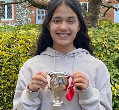 Four Marks singer Jaya Passingham, 14, with The Rowland Owen Trophy which she won for singing at the Godalming Music Festival in March 2022.