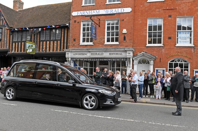 FUNERAL SIR RAY TINDLE MRW 12th May 2022
Sir Ray Tindle’s hearse pauses outside the Herald offices in West Street on its way to St Andrew’s Church
The funeral cortege of Sir Ray Tindle CBE DL passes the office of The Farnham Herald as it made its way to St Andrew's Church Farnham for a Private Family Service
Picture: Malcolm Wells
Professional Photographer