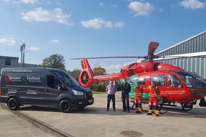 Wayne Spooner is pictured with the Wales Air Ambulance pilot and medics