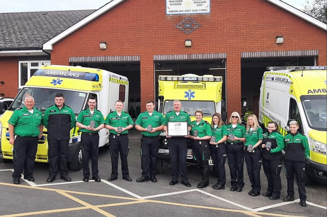 Rhayader First Responders pictured with their plaque from St John Ambulance Cymru, outside their ambulance hall.