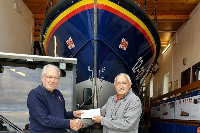  Paul Lewis from Schooner Park residents association presents a cheque to New Quay RNLI’s Lifeboat Operations Manager Roger Couch
