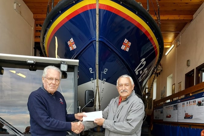 Paul Lewis from Schooner Park residents association presents a cheque to New Quay RNLI’s Lifeboat Operations Manager Roger Couch