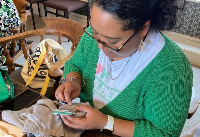Repairer Jennifer Edwards mends a hole in this grey cardigan