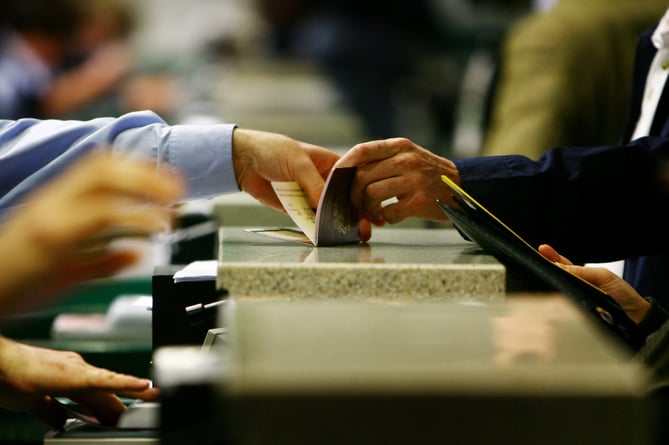 Passports are checked at passport control during the official launch of the UK Border Agency (UKBA) at Gatwick Airport in West Sussex.
