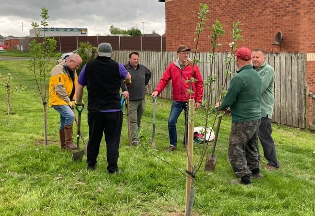 Jake Berriman (third from the right) with residents planting the trees