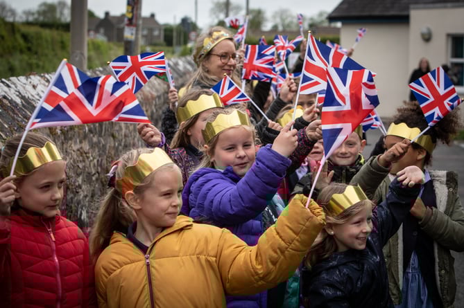 Primary school children from Templeton Community Primary School, Narberth, Pembrokeshire, kick off their Platinum Jubilee celebrations with a colourful parade through the village, waving flags and singing, whilst dressed in their decorated gold crowns and iconic red buses. The children danced a maypole on the village green with red, blue and white ribbons for the onlooking residents, as well as created Platinum Jubilee mosaics which will now remain a permanent fixture in the village.