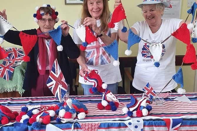 Holding up their bunting, left to right, Dot, Sue Frankham and Terri Saffin. 