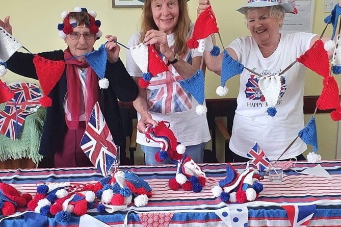Holding up their bunting, left to right, Dot, Sue Frankham and Terri Saffin.
