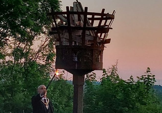 A photo of Ross mayor Ed O’Driscoll lighting the beacon on the Prospect at sunset.