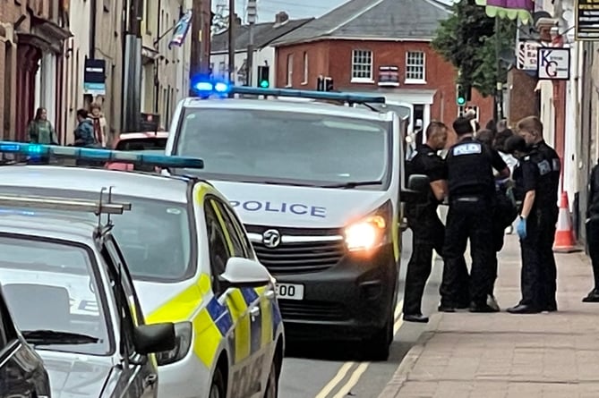 Officers arresting the young man this lunchtime. AQ 9360