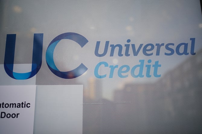EMBARGOED TO 0001 THURSDAY JANUARY 13 File photo dated 06/10/21 of a Universal Credit sign on a door of a job centre plus. The Government should allow more than 100,000 disabled and ill people to seek compensation after a "blunder" saw their benefits mistakenly cut, an ombudsman has warned.