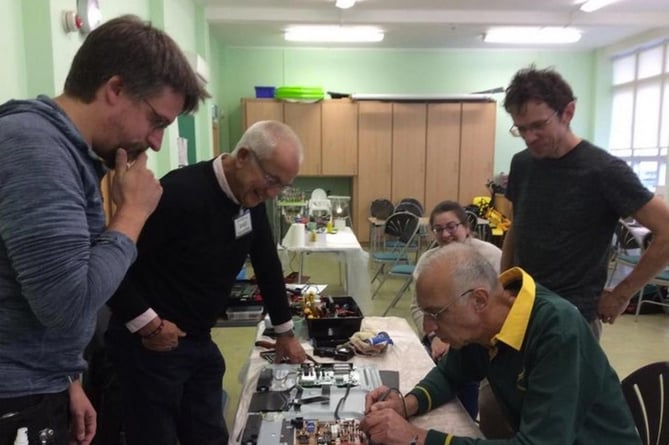 Peasedown St John Repair Café volunteers working on an electrical item.