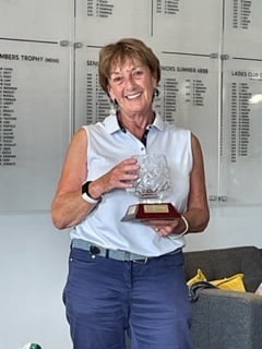 A delighted Lo duly collected the Biddle Flag Trophy from Ladies Captain-elect, Pauline Young, the first time a presentation has been made post pandemic.  