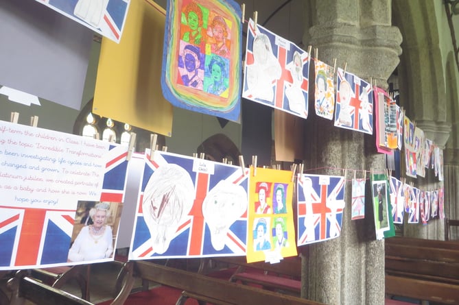 A double row of portraits of the Queen created by pupils of Cheriton Bishop Primary School hung right down through the parish church and back again. SR 2290