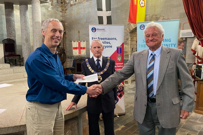 Nigel Cox, Barnardo's Children's Services Manager, receives a donation from Roger Cargeeg, Deputy Provincial Grand Master, and Ivan Barrett, Worshipful Master of Saint Andrews Lodge.jpeg