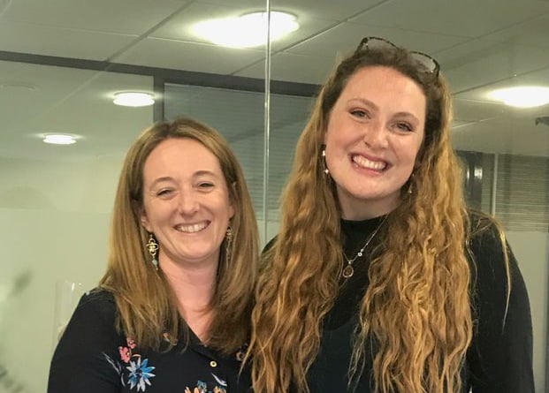 Becky Brooks and Lucy Slade stood handing The Journal over to Lucy.