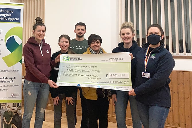 Hywel Dda Health Charities’ fundraising officer Bridget Harpwood is pictured (far right) accepting the cheque from YFC members Caryl George, Ella Edwards, Iestyn Davies, Jen Davies and Siwan George