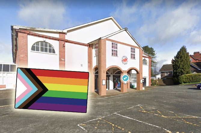 The progressive Pride flag inset over a photo of the Pavilion on Google Street View