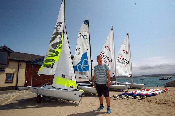 Dovey Yacht Club Sailing Club committee member and project lead Huw Jones-Williams with the four Sport Wales grant funded boats and sail sets