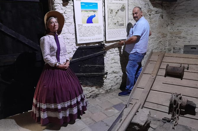 Historic barge tiller displayed at Morwellham Quay by Martyn Langsford of South West Water and Tessa Wannell of the quay
