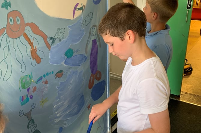 Children at the SJ’s After School Club in Peasedown St John painting the new mural.