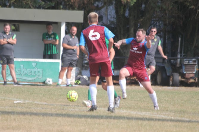 Launceston attacker Tom Ellacott (right, claret) gets ready to make a tackle during Saturday’s home clash with St Blazey in SWPL Premier West.