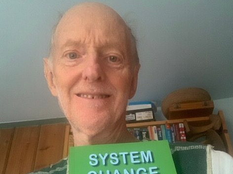 Richard Priestley with his book “System Change Now!”