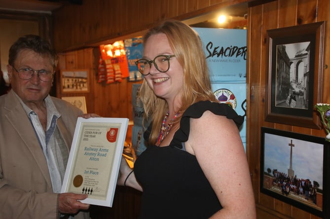 Tony Davis, East Hants CAMRA branch secretary and pubs officer presenting the Cider Pub of the Year certificate to The Railway Arms landlady Chloe Watson
