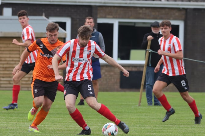 Ayre Utd’s Declan Cummins (left) and Peel’s Sam Kennaugh in action during last weekend’s Canada Life Premier League clash in Andreas